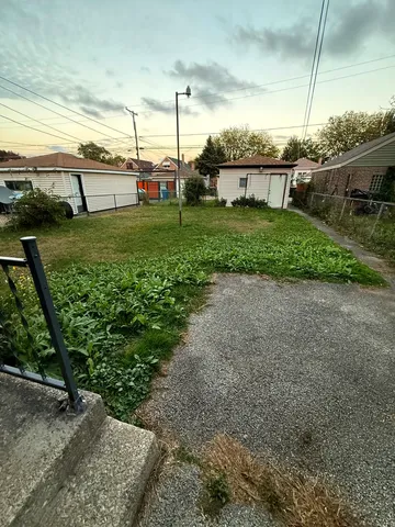 a view of a backyard with sitting area