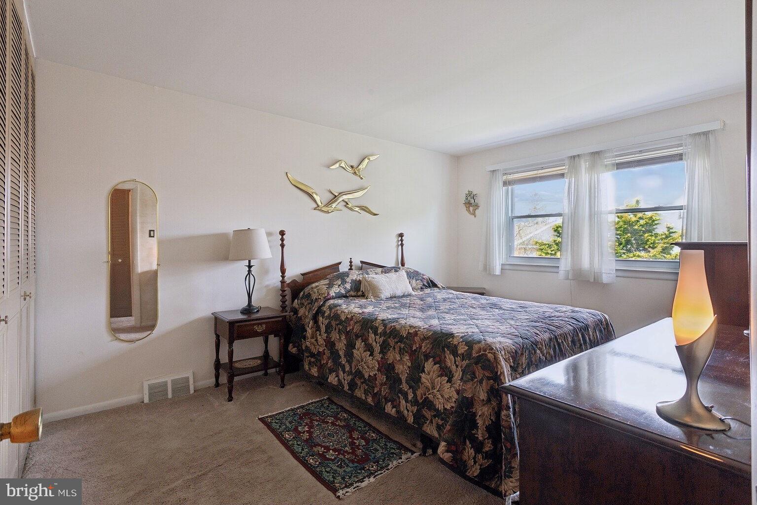 12010 Academy Road Philadelphia, PA 19154 - Photo 15 of 30 a bed sitting in a bedroom next to a window