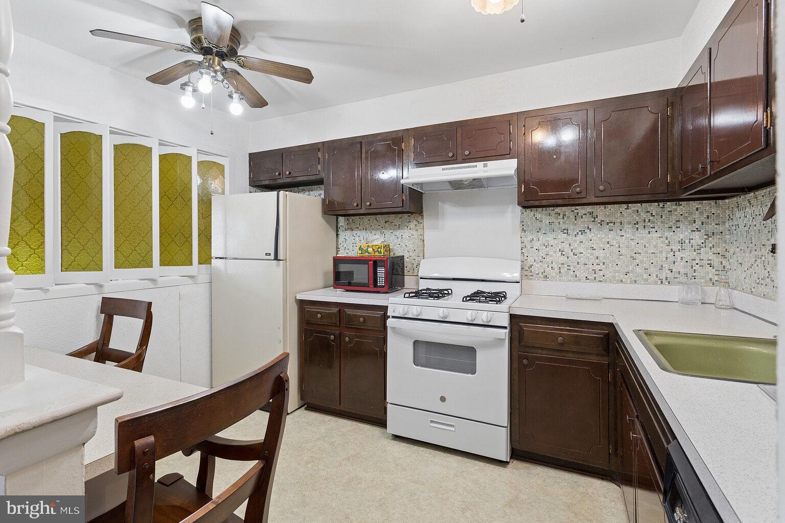 12010 Academy Road Philadelphia, PA 19154 - Photo 10 of 30 a kitchen with a stove sink and cabinets