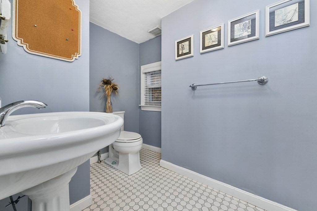 67 Broadway, Unit 1 Chelsea, MA 02150 - Photo 13 of 20 a bathroom with a sink a toilet and a mirror