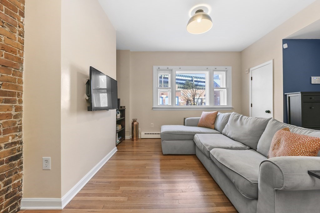 67 Broadway, Unit 1 Chelsea, MA 02150 - Photo 2 of 20 a living room with furniture and a window