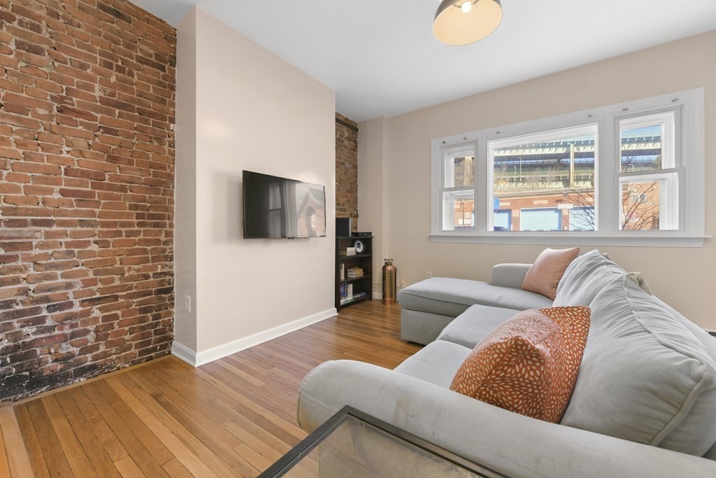 67 Broadway, Unit 1 Chelsea, MA 02150 - Photo 3 of 20 a living room with furniture and a flat screen tv