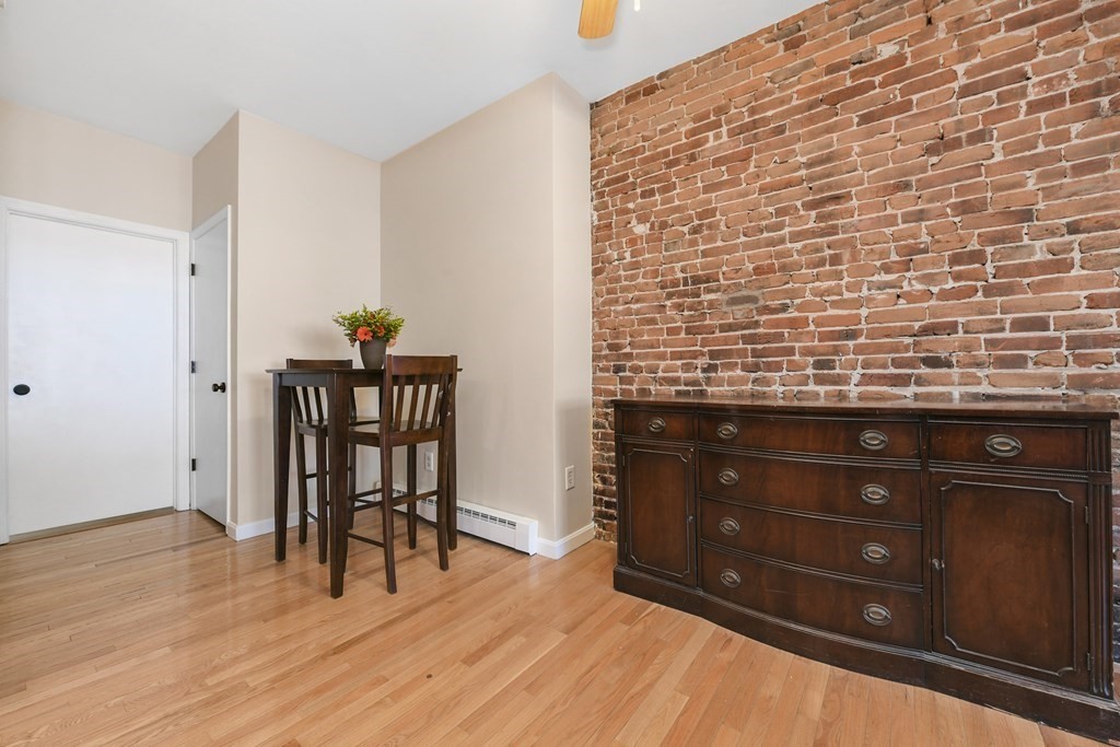 67 Broadway, Unit 1 Chelsea, MA 02150 - Photo 8 of 20 a room with a wooden cabinets and furniture