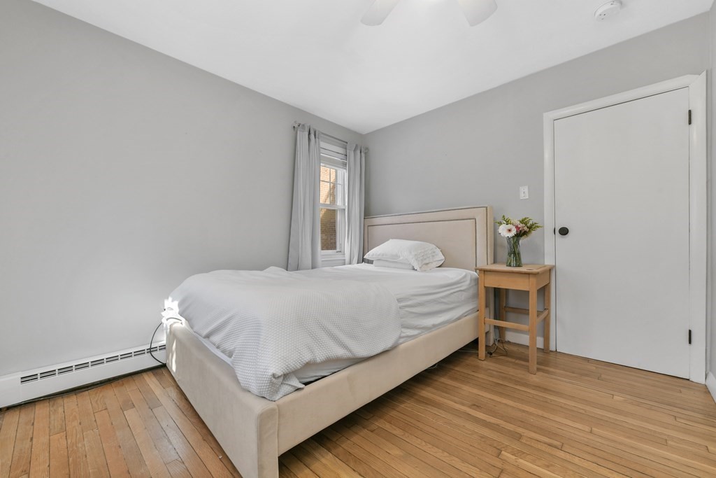 67 Broadway, Unit 1 Chelsea, MA 02150 - Photo 10 of 20 a bedroom with a bed and a window