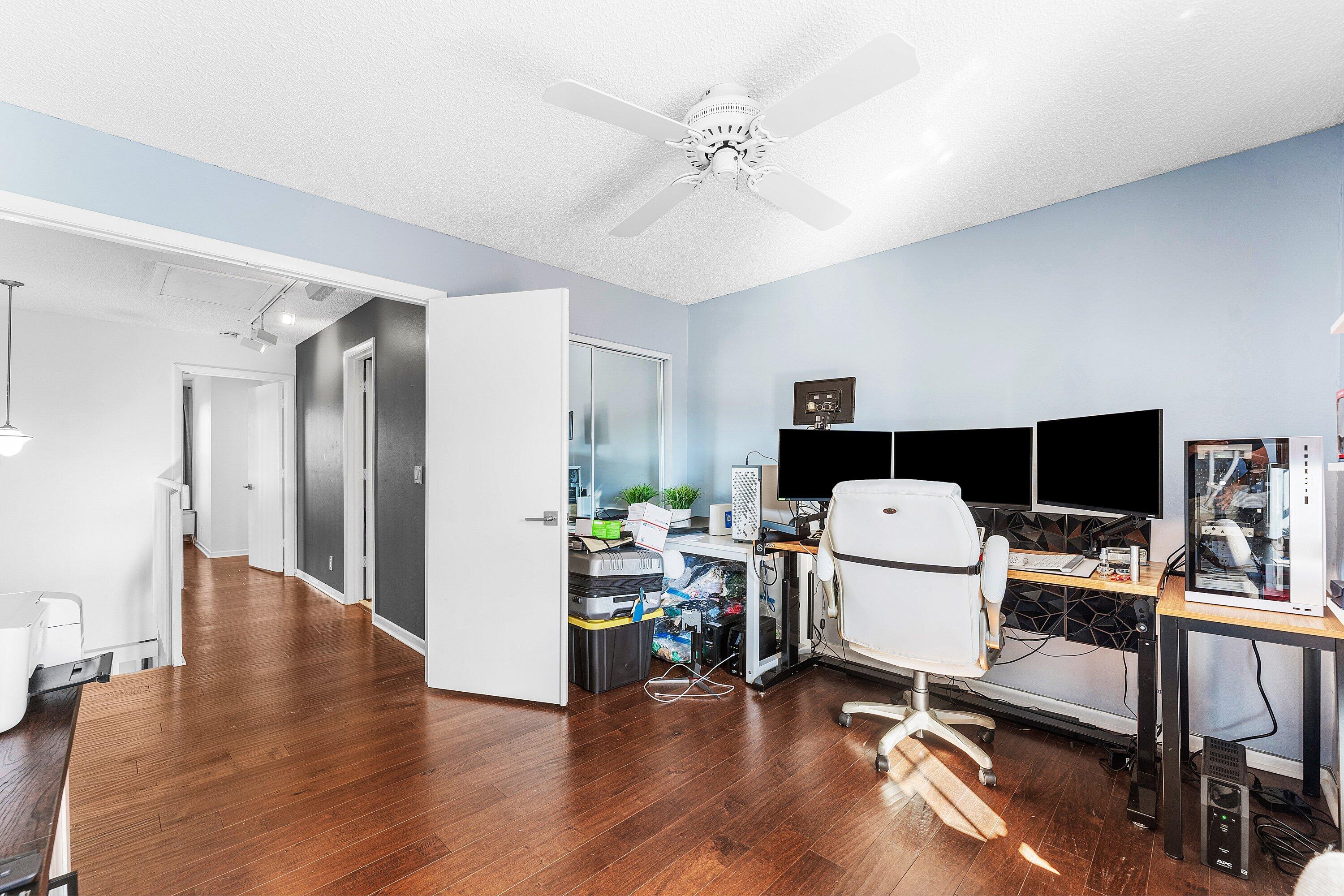 19931 Villa Lante Place Boca Raton, FL 33434 - Photo 22 of 47 a view of a workspace with furniture and a flat screen tv