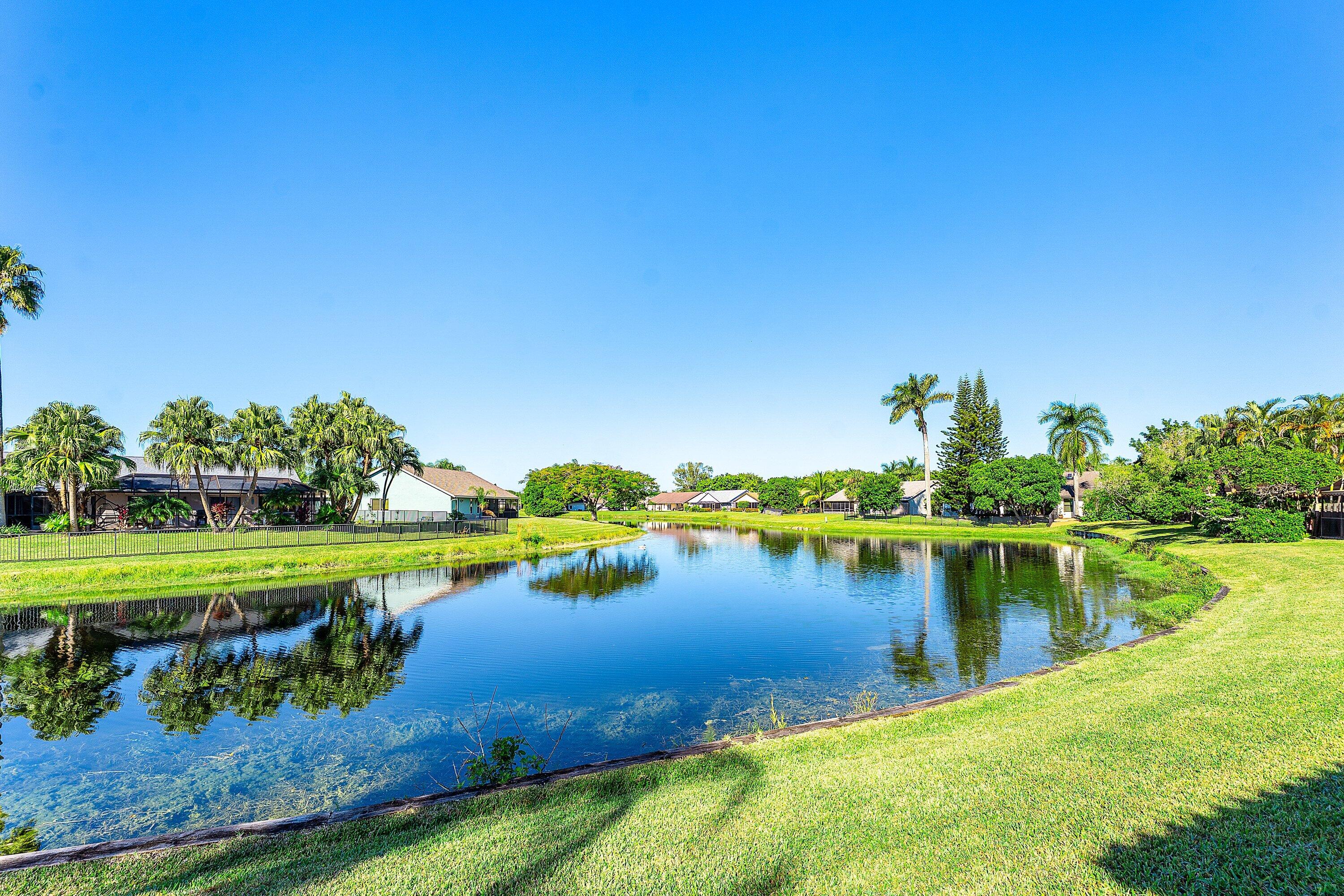 19931 Villa Lante Place Boca Raton, FL 33434 - Photo 33 of 47 a view of a lake with a house in the background