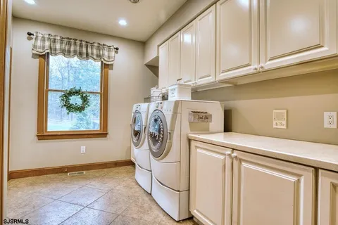 a view of washer and dryer with kitchen in the background