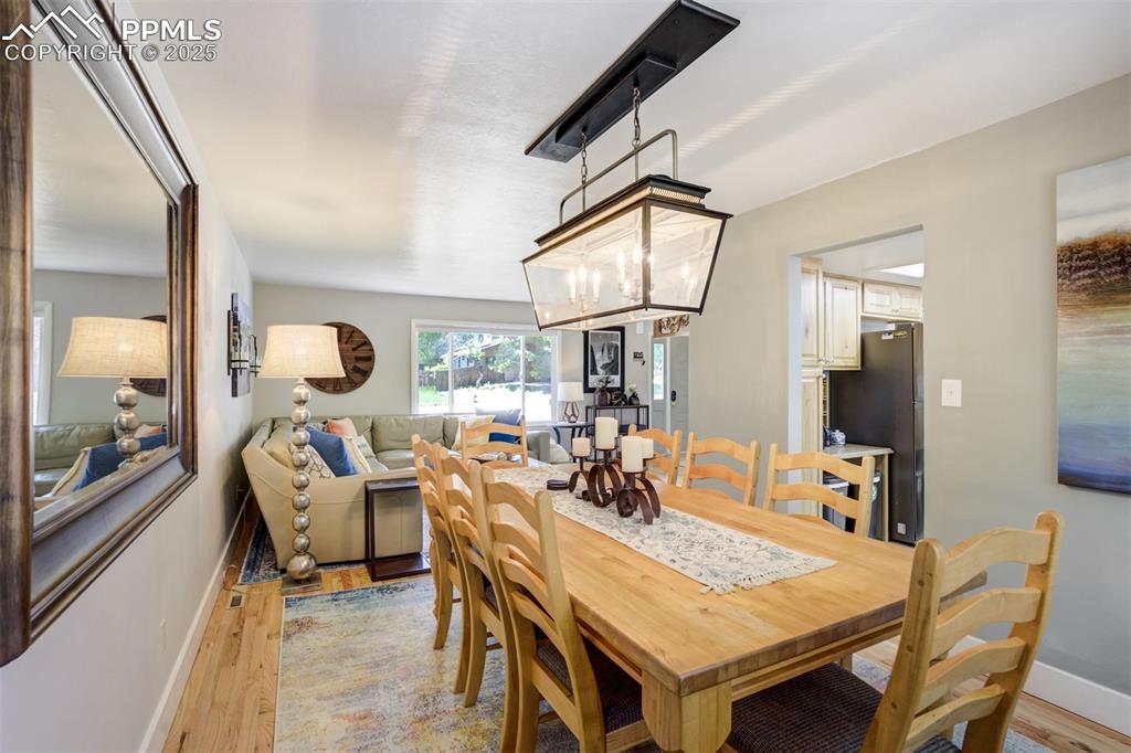 535 Silver Spring Circle Colorado Springs, CO 80919 - Photo 11 of 50 a living room with dining table and a large mirror on the table