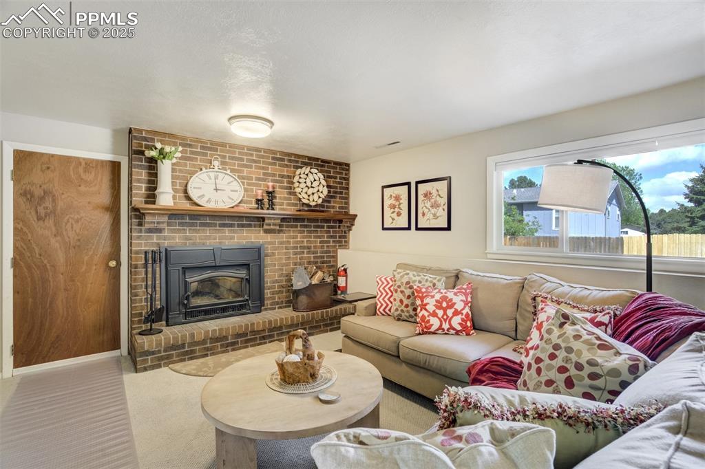 535 Silver Spring Circle Colorado Springs, CO 80919 - Photo 20 of 50 a living room with furniture and a fireplace