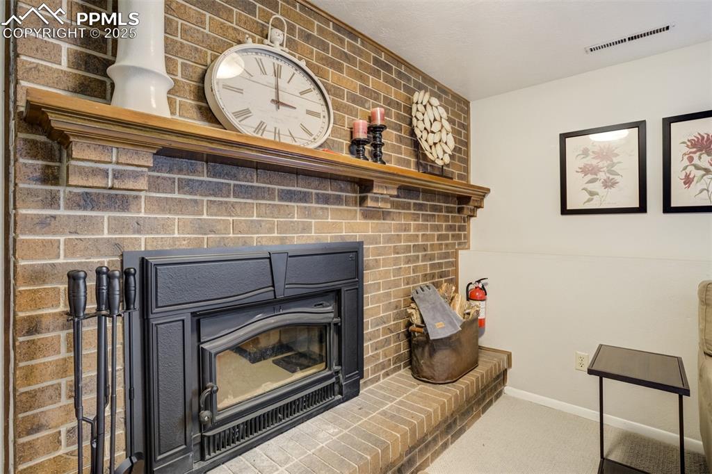 535 Silver Spring Circle Colorado Springs, CO 80919 - Photo 21 of 50 a living room with furniture and a fireplace