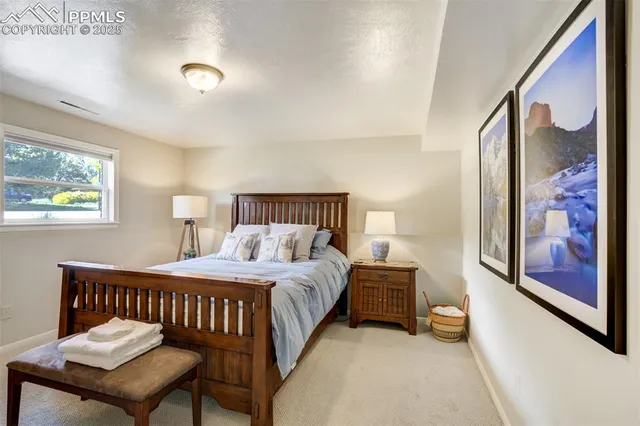 a bedroom with a bed and a lamp on table