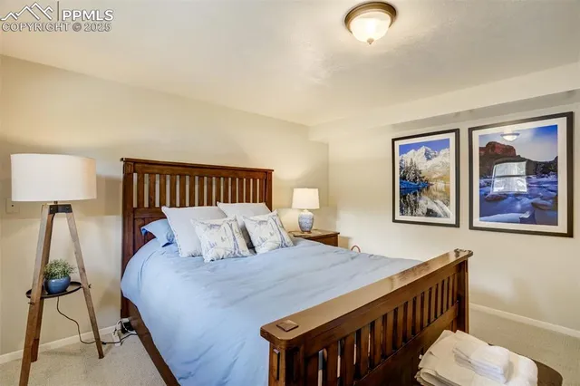 a bedroom with a bed and a dresser next to a window