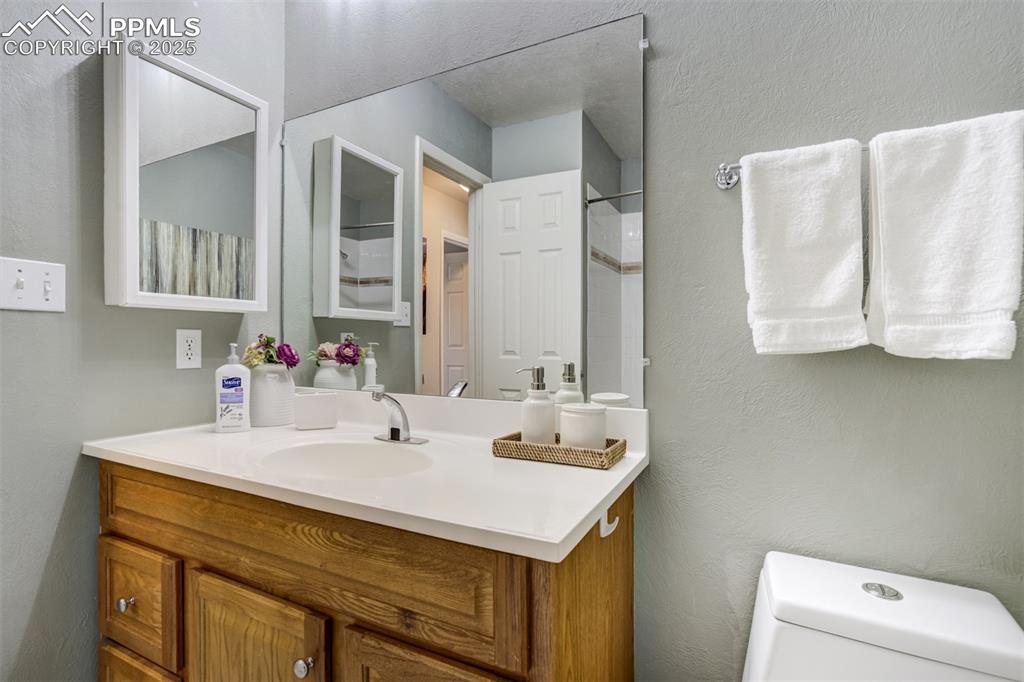 535 Silver Spring Circle Colorado Springs, CO 80919 - Photo 28 of 50 a bathroom with a sink and a mirror