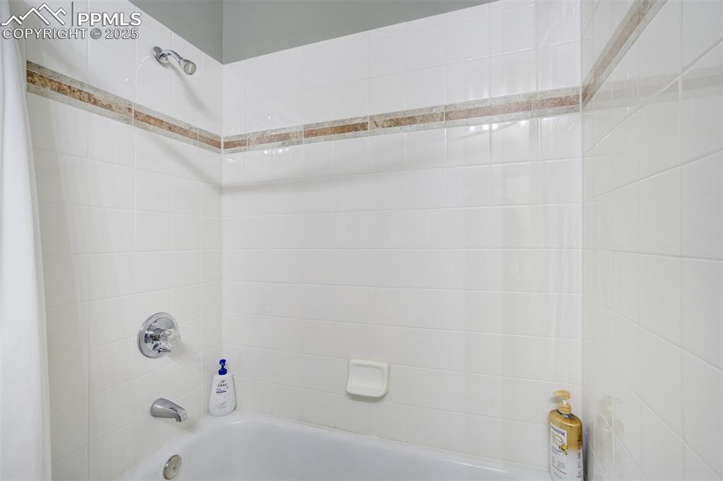 535 Silver Spring Circle Colorado Springs, CO 80919 - Photo 29 of 50 a bathroom with a shower and a bathtub