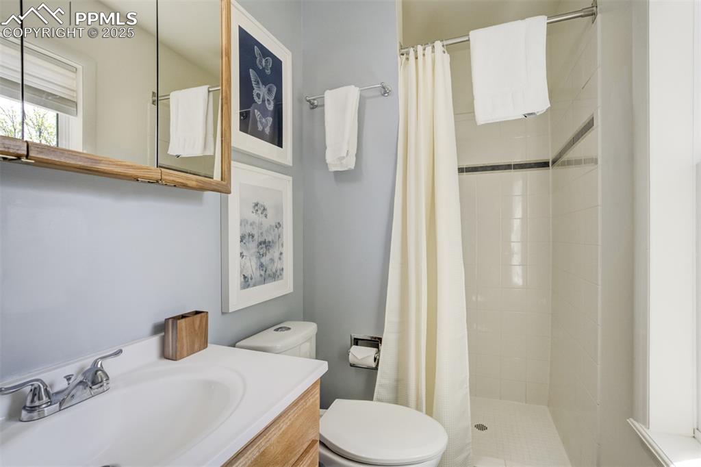 535 Silver Spring Circle Colorado Springs, CO 80919 - Photo 32 of 50 a bathroom with a sink toilet and shower