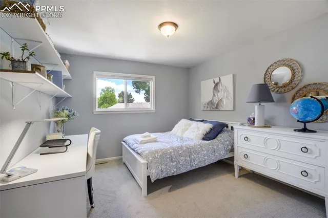 a bed room with a bed and a painting on the wall