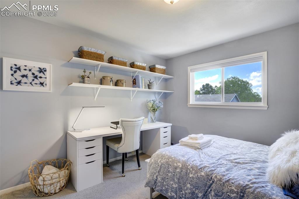 535 Silver Spring Circle Colorado Springs, CO 80919 - Photo 35 of 50 a bedroom with a bed and a window