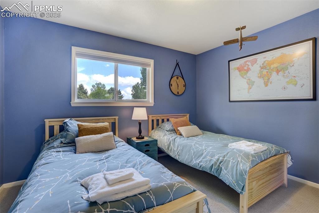 535 Silver Spring Circle Colorado Springs, CO 80919 - Photo 38 of 50 a bedroom with bed and a couch