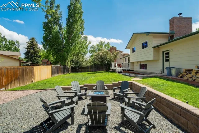 a view of a house with backyard and sitting area