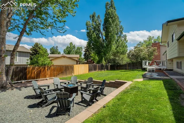 a view of a house with a yard and sitting area