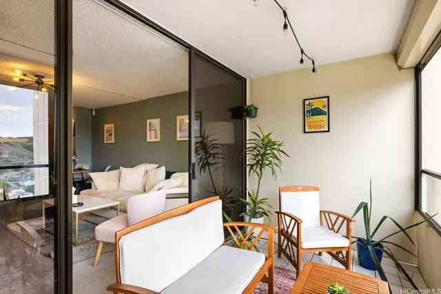 a living room with furniture and a floor to ceiling window