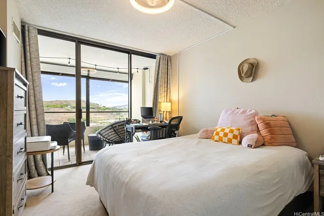 a bedroom with a bed and a large window