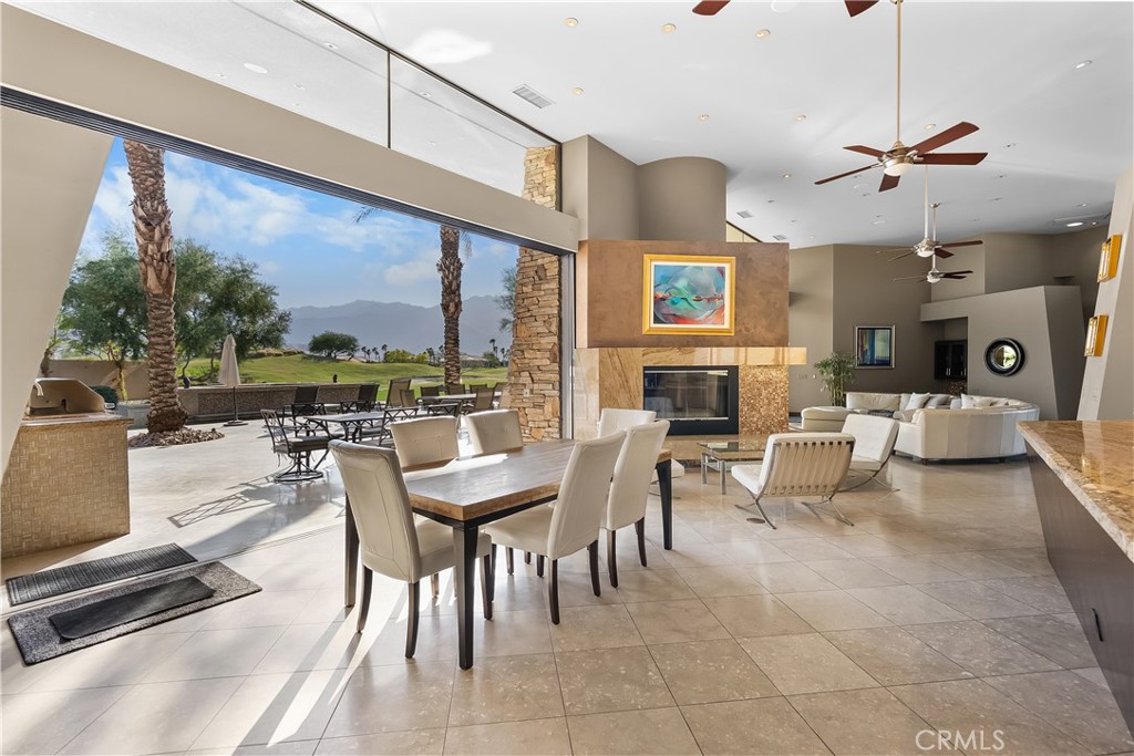 68 Royal St Georges Way Rancho Mirage, CA 92270 - Photo 11 of 73 a living room with fireplace furniture and a large window