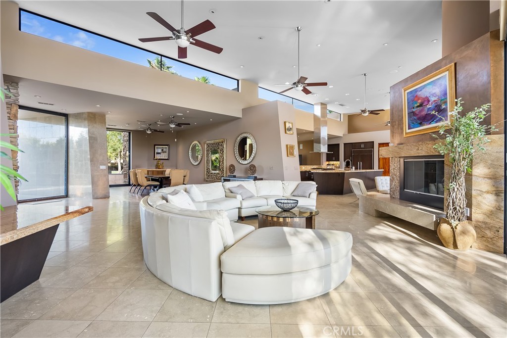 68 Royal St Georges Way Rancho Mirage, CA 92270 - Photo 13 of 73 a living room with furniture a fireplace and a flat screen tv
