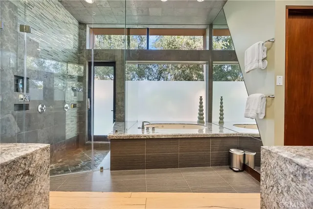 a living room with garden view and a potted plant