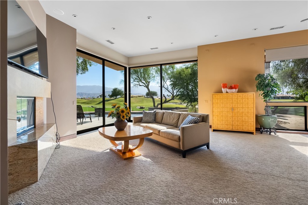 68 Royal St Georges Way Rancho Mirage, CA 92270 - Photo 24 of 73 a living room with furniture and a large window