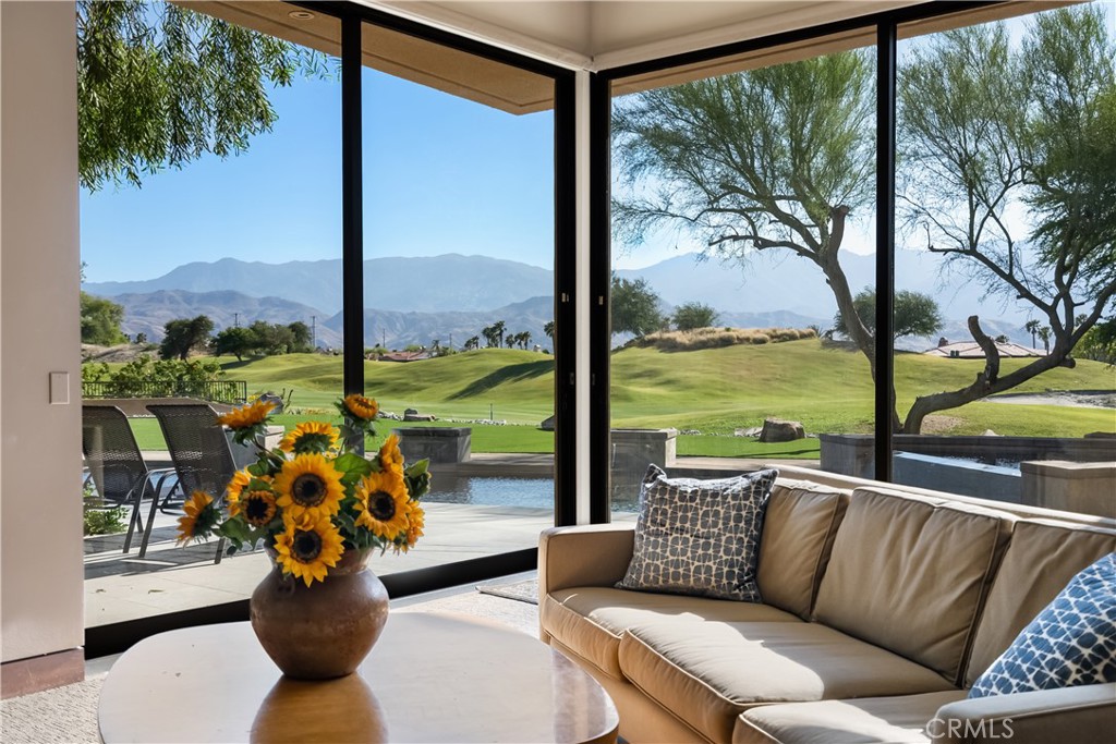 68 Royal St Georges Way Rancho Mirage, CA 92270 - Photo 25 of 73 a living room with garden view and a potted plant