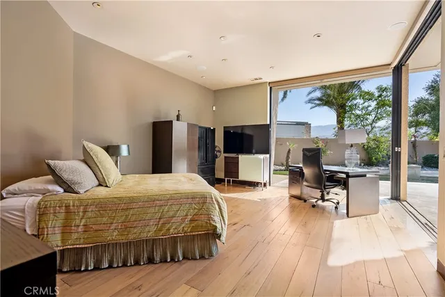 a bedroom with a bed and dresser with mirror