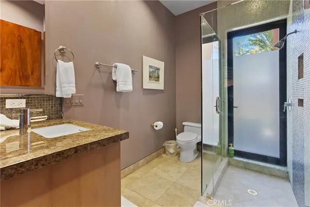 a bedroom with a bed and a mirror