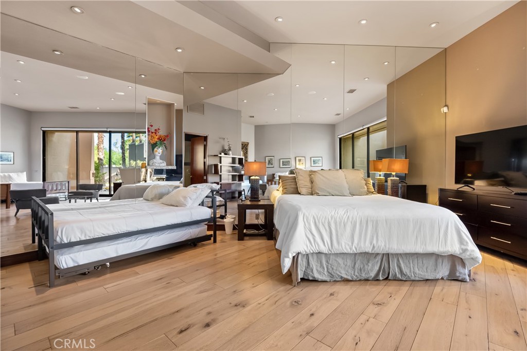 68 Royal St Georges Way Rancho Mirage, CA 92270 - Photo 45 of 73 a large bedroom with a large bed and flat tv screen