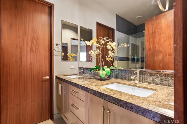 a bathroom with a granite countertop sink toilet and shower