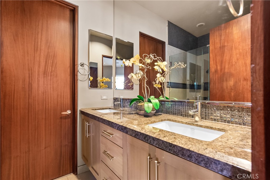 68 Royal St Georges Way Rancho Mirage, CA 92270 - Photo 47 of 73 a bathroom with a granite countertop sink and a mirror