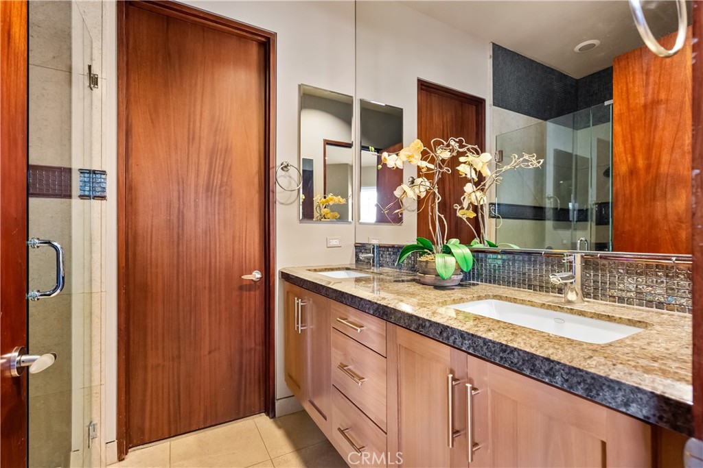 68 Royal St Georges Way Rancho Mirage, CA 92270 - Photo 48 of 73 a bathroom with a granite countertop sink and a mirror