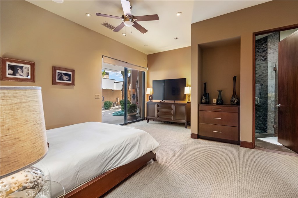 68 Royal St Georges Way Rancho Mirage, CA 92270 - Photo 51 of 73 a bedroom with a bed and a flat tv screen on dresser