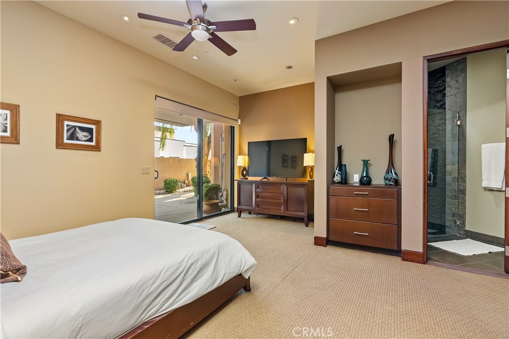 68 Royal St Georges Way Rancho Mirage, CA 92270 - Photo 55 of 73 a bedroom with a bed and a chandelier