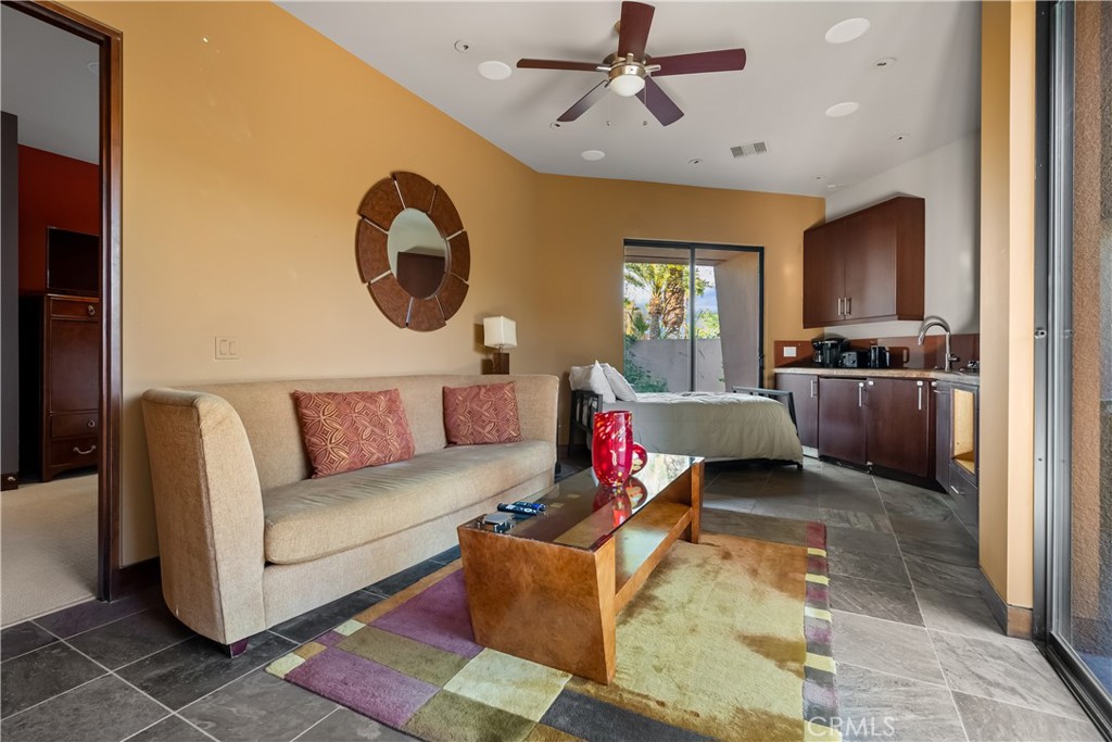 68 Royal St Georges Way Rancho Mirage, CA 92270 - Photo 56 of 73 a living room with furniture a flat screen tv and kitchen view