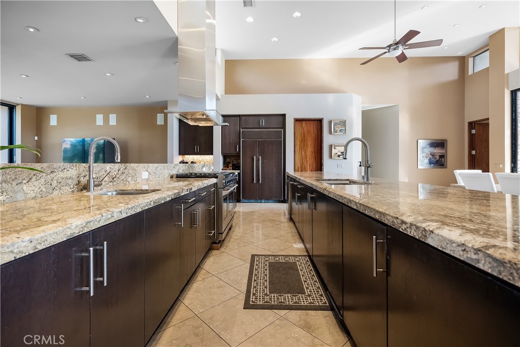 68 Royal St Georges Way Rancho Mirage, CA 92270 - Photo 6 of 73 a large kitchen with granite countertop a sink and cabinets