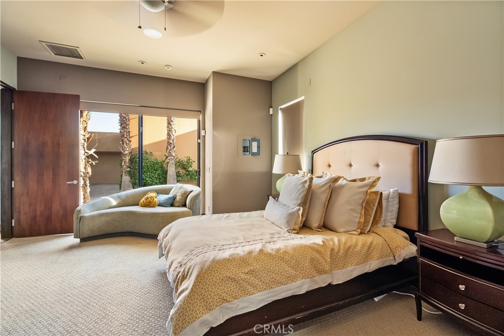 68 Royal St Georges Way Rancho Mirage, CA 92270 - Photo 66 of 73 a bedroom with a bed a lamp and window