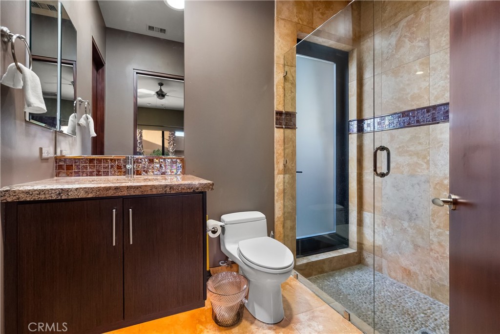 68 Royal St Georges Way Rancho Mirage, CA 92270 - Photo 67 of 73 a bathroom with a granite countertop sink toilet and shower