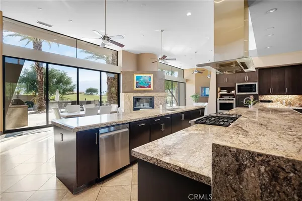 a living room with fireplace furniture and a large window