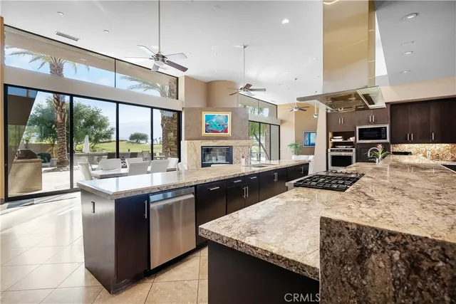 a living room with fireplace furniture and a large window