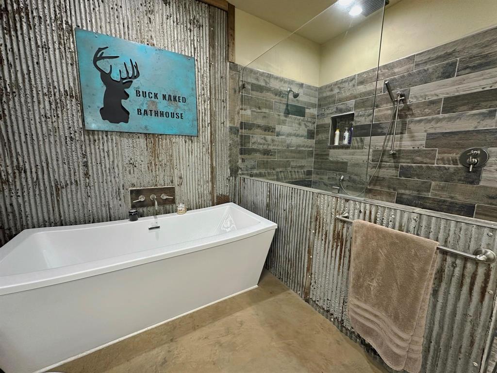 1990 Jim Harry Loop Sunset, TX 76270 - Photo 10 of 39 a bathroom with a bathtub and shower