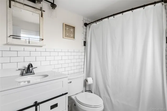 a kitchen with stainless steel appliances a dining table chairs and wooden floor
