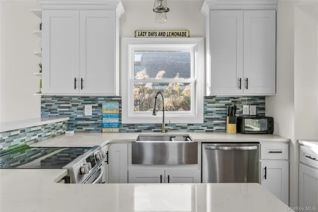 a kitchen with stainless steel appliances granite countertop a sink a stove and a microwave