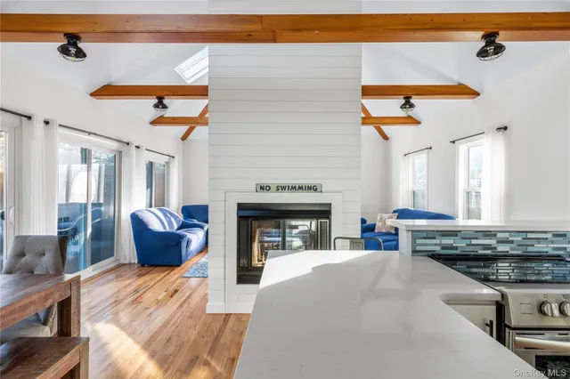 a view of a kitchen with a stove cabinets and a floor to ceiling window