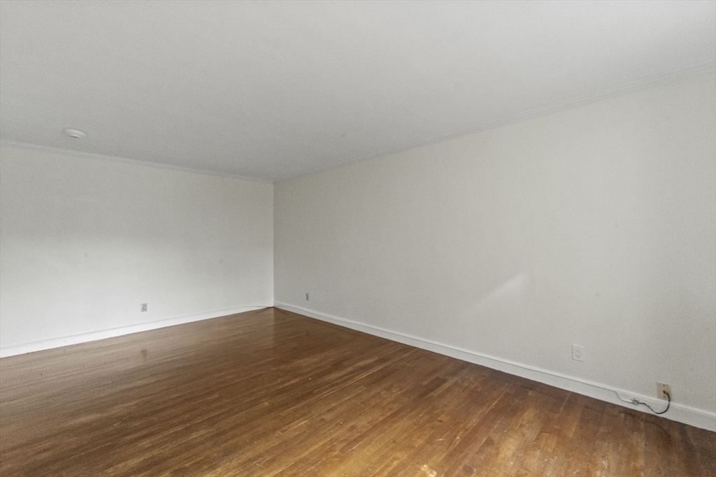 38-40 Cedar Street, Unit 335 Worcester, MA 01609 - Photo 13 of 21 a view of an empty room with wooden floor